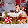 Isaac a rejoint le concours — aidez-le/la à gagner de superbes lots ! baby, basket, child, christmas_tree, cute, decorations, festive, fur_rug, gifts, holiday, ornaments, plush_toy, presents, red_decorations, santa_hat, studio_portrait, teddy_bear, tinsel, toy_bear, white_backdrop