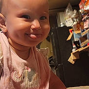 Rosaelia is registered to the contest to win money with this photo: accessories, baby, bodypart, clothing, face, finger, furniture, hand, happy, head, indoors, laughing, lighting, person, photography, portrait, sitting, smile, t_shirt, wood