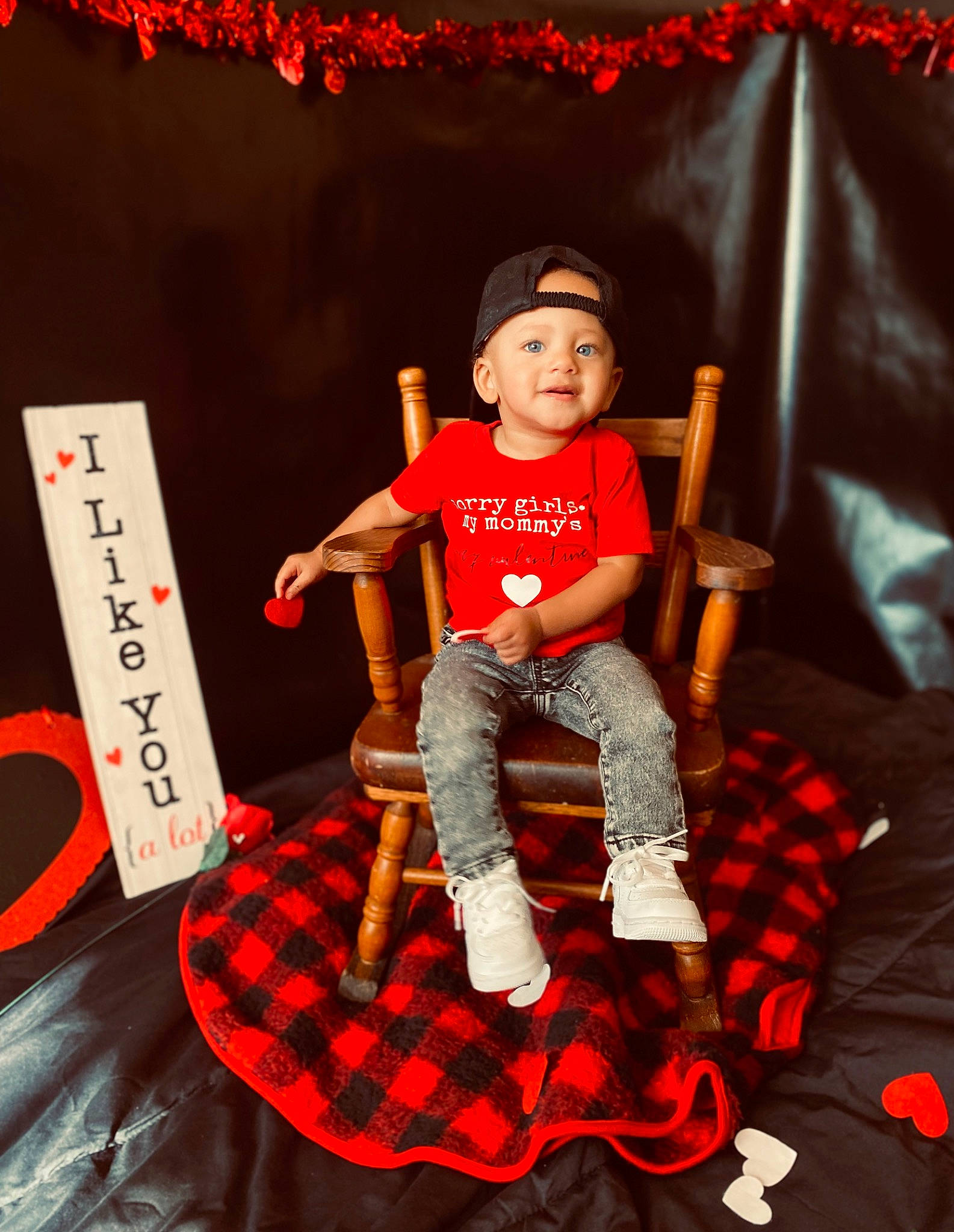 Kylen joined the competition — help win amazing prizes! carmine, chair, doll, elbow, entertainment, event, fashion_design, fun, hat, headwear, knee, pattern, performing_arts, person, plaid, red, shorts, sitting, sleeve, t_shirt