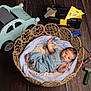 Célio a rejoint le concours — aidez-le/la à gagner de superbes lots ! baby, newborn, infant, basket, wicker_basket, blanket, overalls, blue_overalls, toy_tools, toy_hammer, toy_wrench, toolbox, wooden_toy_car, wood_floor, studio_photo, props, lying_down, cute, portrait, newborn_photography
