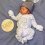 Kalen is registered to the contest to win money with this photo: baby, beanie, bed, blanket, bonnet, cap, clothing, costume, face, furniture, glove, hat, head, newborn, pants, person, photography, portrait, sleeping, yawning