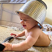 Kalen joined the competition — help win amazing prizes! baby, babylaughing, bed, bedroom, clothing, crawling, device, diaper, face, furniture, happy, hardhat, head, helmet, indoors, person, photography, portrait, room, sitting