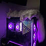 Yeti is registered to the contest to win money with this photo: cat, white_cat, sleeping, gaming_pc, computer, purple_light, led_fans, technology, indoor, pet, fluffy_tail, electronics, relaxed, night, dark_room, hardware, desktop_pc, computer_case, cooling_fans, purple_glow