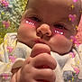 Arielle is registered to the contest to win money with this photo: baby, infant, close_up, face, hand, onesie, cartoon_print, blanket, pink_hearts, sparkles, cute, expression, indoors, soft_lighting, child, portrait, sleepwear, skin, young_child, adorable