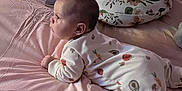 Arielle is registered to the contest to win money with this photo: baby, bed, blanket, book, child, clothing, comfort, cushion, face, floral_pattern, furniture, homedecor, infant, nursing_pillow, onesie, person, pink, portrait, rest, soft
