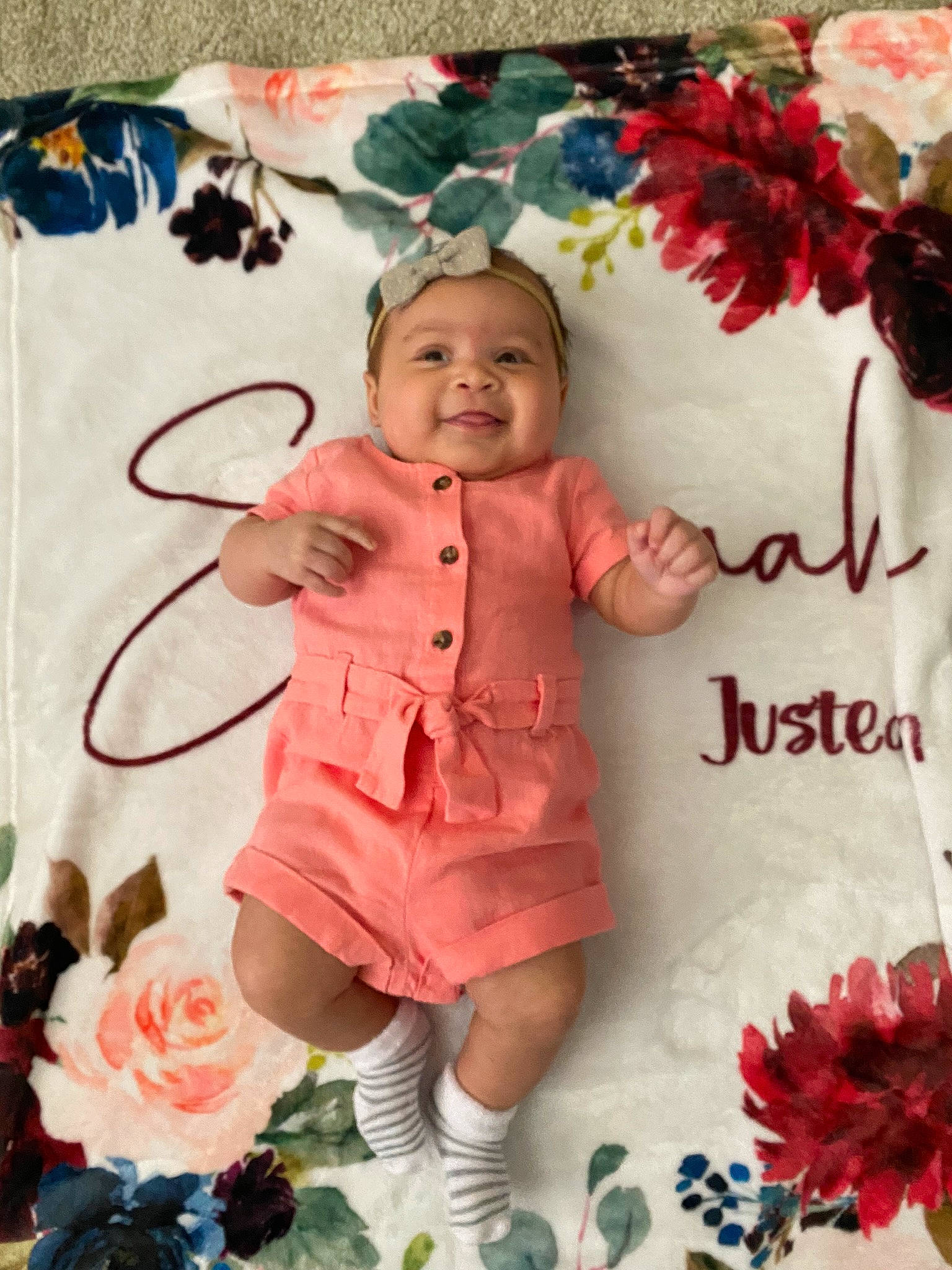 Eliyanah is registered to the contest to win money with this photo: baby, baby_toddler_clothing, child, cut_flowers, event, floral_design, flower, font, happy, headwear, icing, joy, magenta, pattern, peach, person, petal, pink, rose, smile