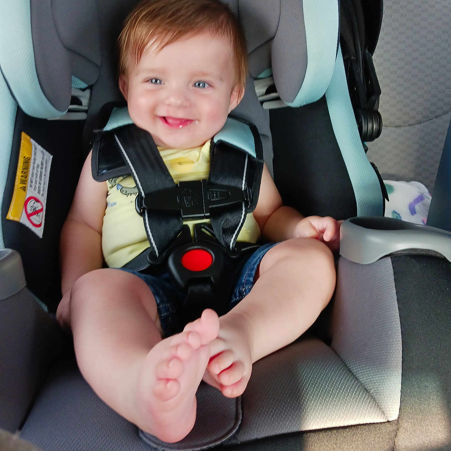 Braxton is registered to the contest to win money with this photo: accessories, baby, bodypart, car, car_interior, carseat, clothing, cushion, face, finger, hand, head, homedecor, person, photography, portrait, sitting, transportation, vehicle, vest