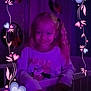 Laura participe au concours pour gagner de l'argent avec cette photo : child, girl, crib, purple_light, pigtails, smile, bedroom, heart_border, nighttime, curtains, long_sleeve_shirt, indoor, happy, young, person, decorative_frame, cute, soft_lighting, portrait, casual_clothing
