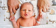 Raylyn is registered to the contest to win money with this photo: newborn, baby, infant, hand_holding, adult_hands, hospital_wristband, blanket, cartoon_characters, bed, cute, family, parental_love, skin, portrait, closeup, expression, lying_down, baby_face, newborn_baby, tender_moment