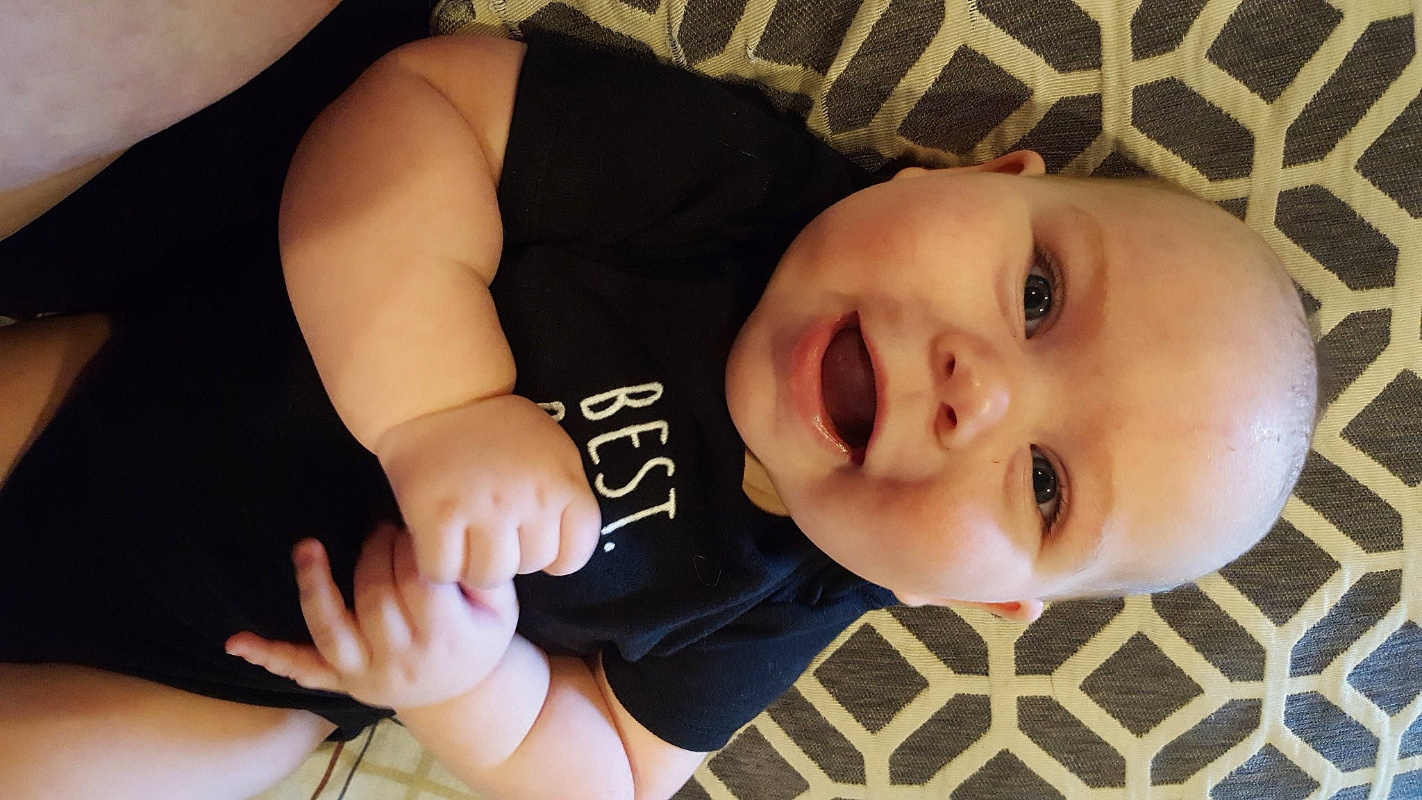 Abram is registered to the contest to win money with this photo: arm, baby, cheek, child, chin, ear, eye, face, facial_expression, finger, hand, head, headwear, lip, mouth, neck, nose, person, skin, smile