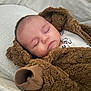 Albie joined the competition — help win amazing prizes! baby, sleeping, infant, brown_jacket, fluffy, cozy, crib, blanket, cute, soft, child, apparel, face, closed_eyes, newborn, warm, resting, indoor, portrait, person