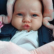 Mia participe au concours pour gagner de l'argent avec cette photo : baby, infant, face, blanket, pink, expression, closeup, cute, child, clothing, warm, soft, pout, looking, head, person, newborn, wrapped, cozy, indoors
