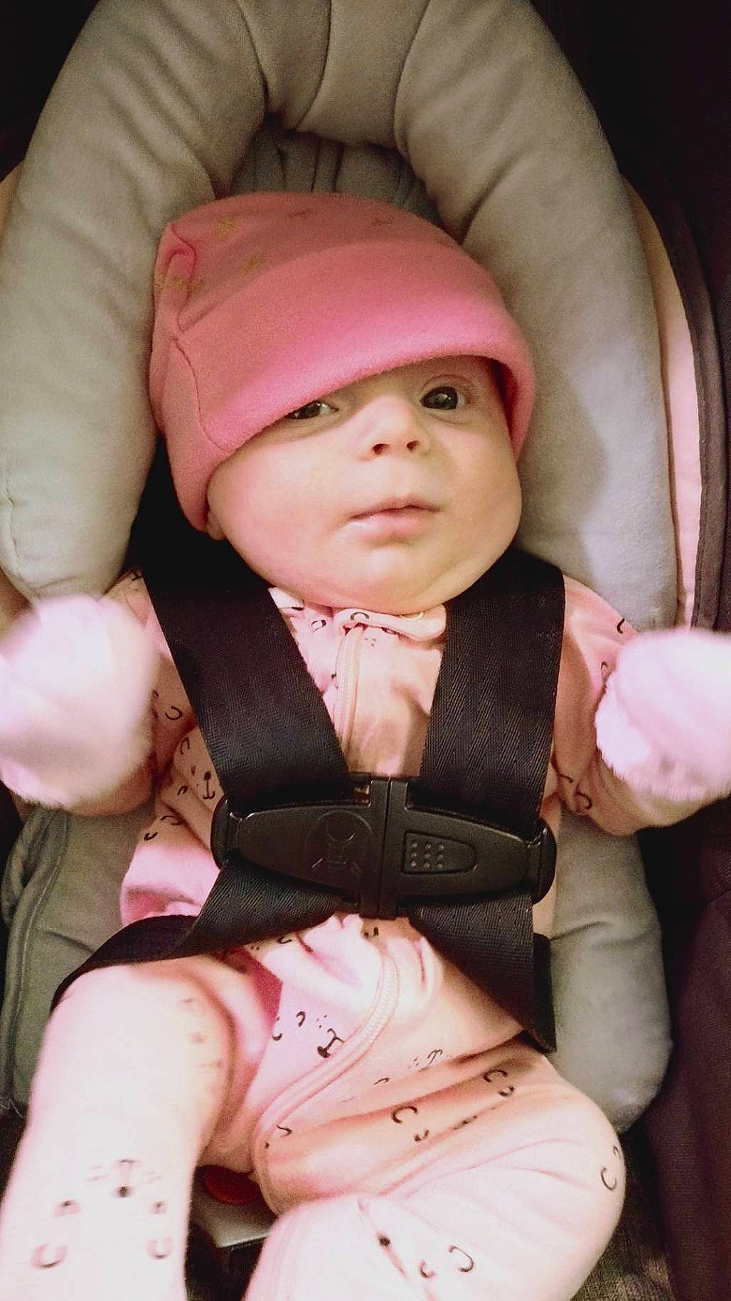 Adeline is registered to the contest to win money with this photo: abdomen, baby, baby_carriage, baby_products, baby_toddler_clothing, beauty, cap, cheek, chest, child, comfort, finger, helmet, person, personal_protective_equipment, pink, sitting, skin, sleeve, toddler