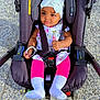 Ina a rejoint le concours — aidez-le/la à gagner de superbes lots ! baby, child, stroller, seatbelt, headwrap, floral_clothing, pink_leggings, white_socks, outdoor, pavement, sunlight, infant, cute, portrait, toddler, sitting, baby_girl, safety_harness, headwear, daylight