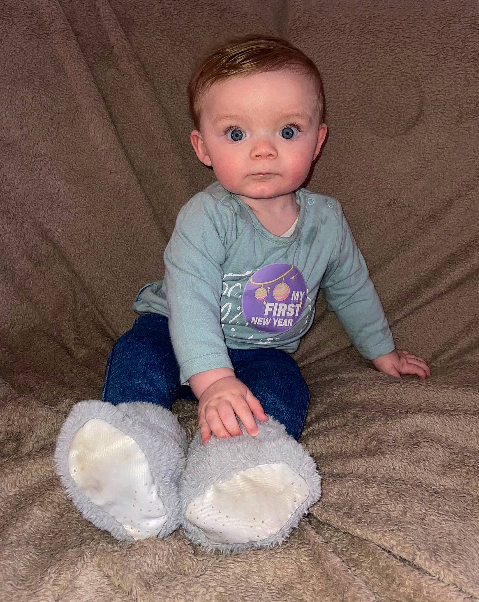 Louie joined the competition — help win amazing prizes! baby, baby_toddler_clothing, cheek, child, comfort, electric_blue, eye, floor, flooring, head, nose, pattern, person, sitting, skin, sleeve, sock, t_shirt, toddler, wood