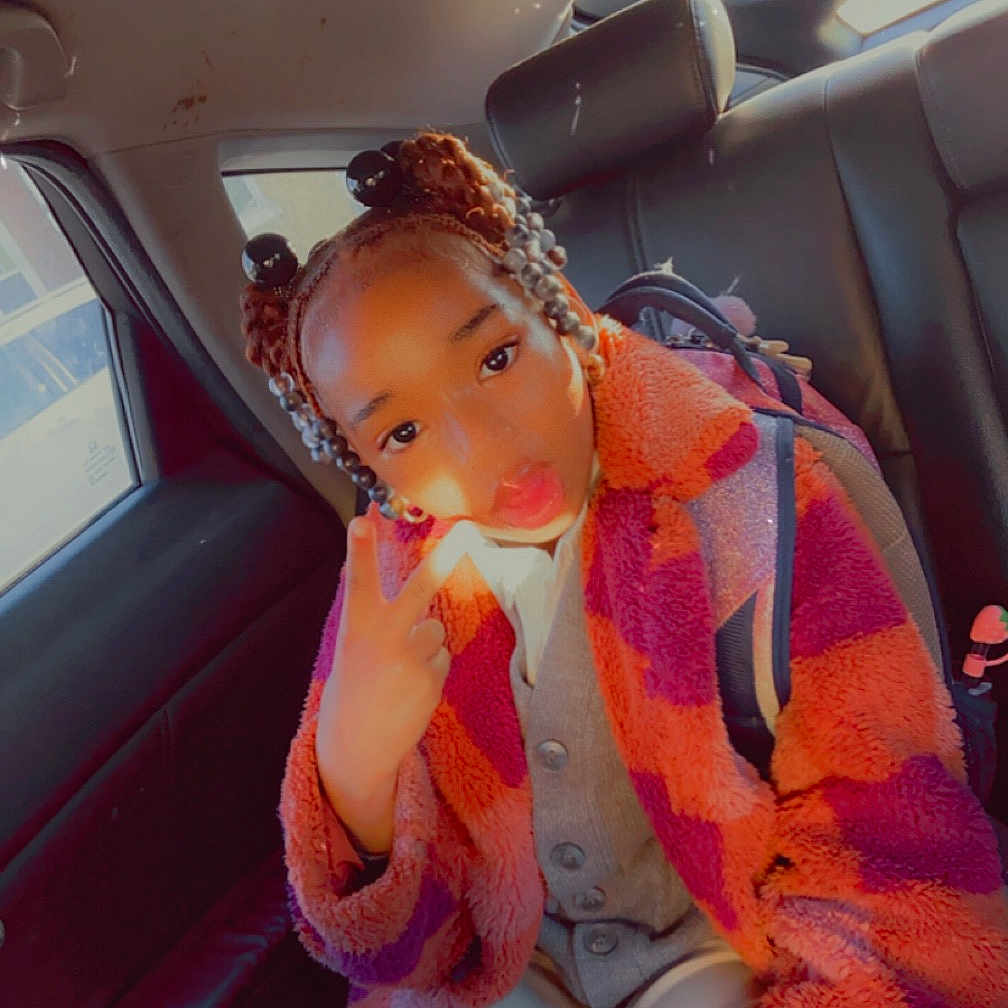 Trevino is registered to the contest to win money with this photo: accessories, baby, belt, car, car_interior, carseat, clothing, coat, cushion, face, head, homedecor, jacket, knitwear, person, photography, portrait, sweater, transportation, vehicle