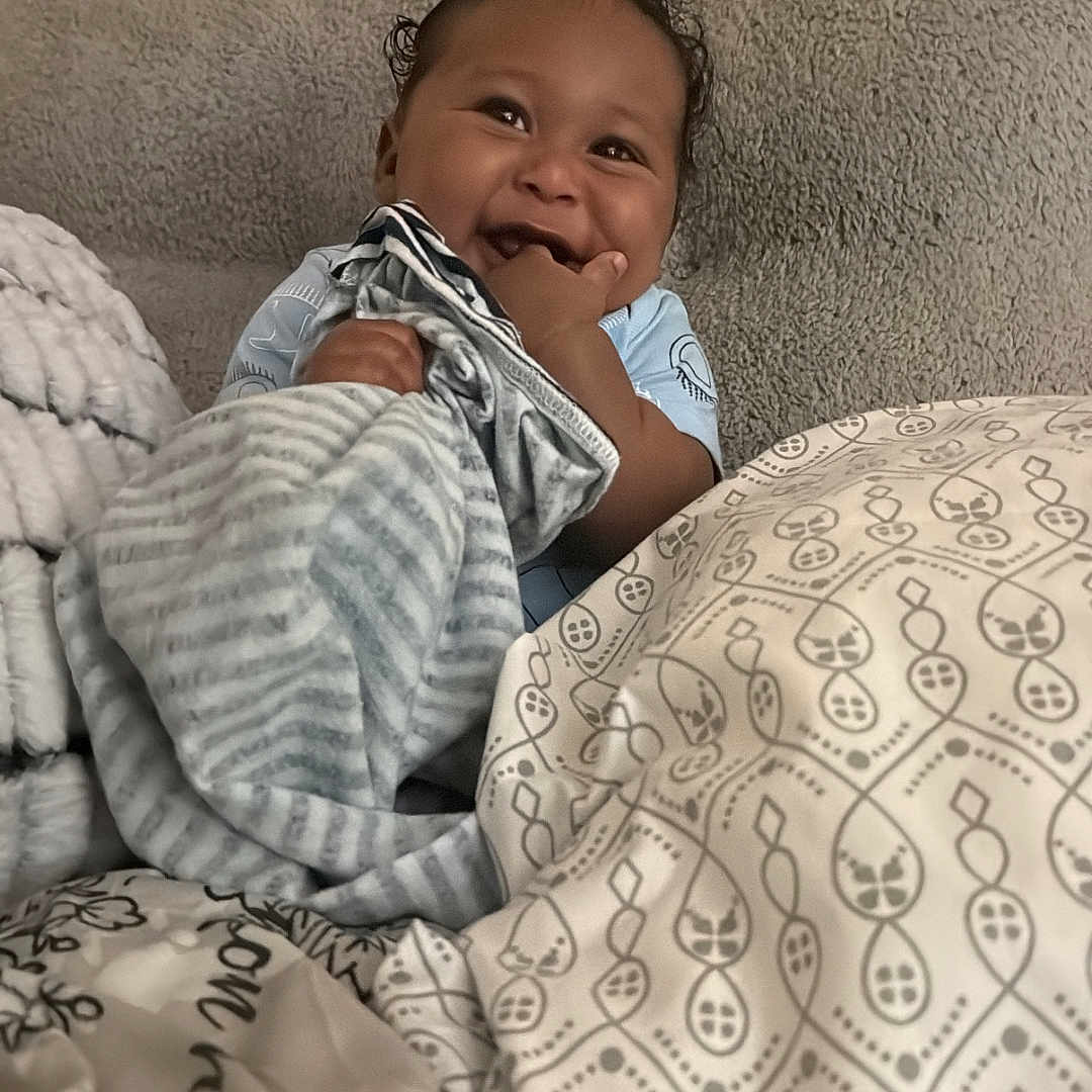 Saire-Naeem joined the competition — help win amazing prizes! baby, bed, blanket, bodypart, couch, cushion, face, finger, furniture, hand, happy, head, homedecor, laughing, newborn, person, photography, portrait, quilt, smile