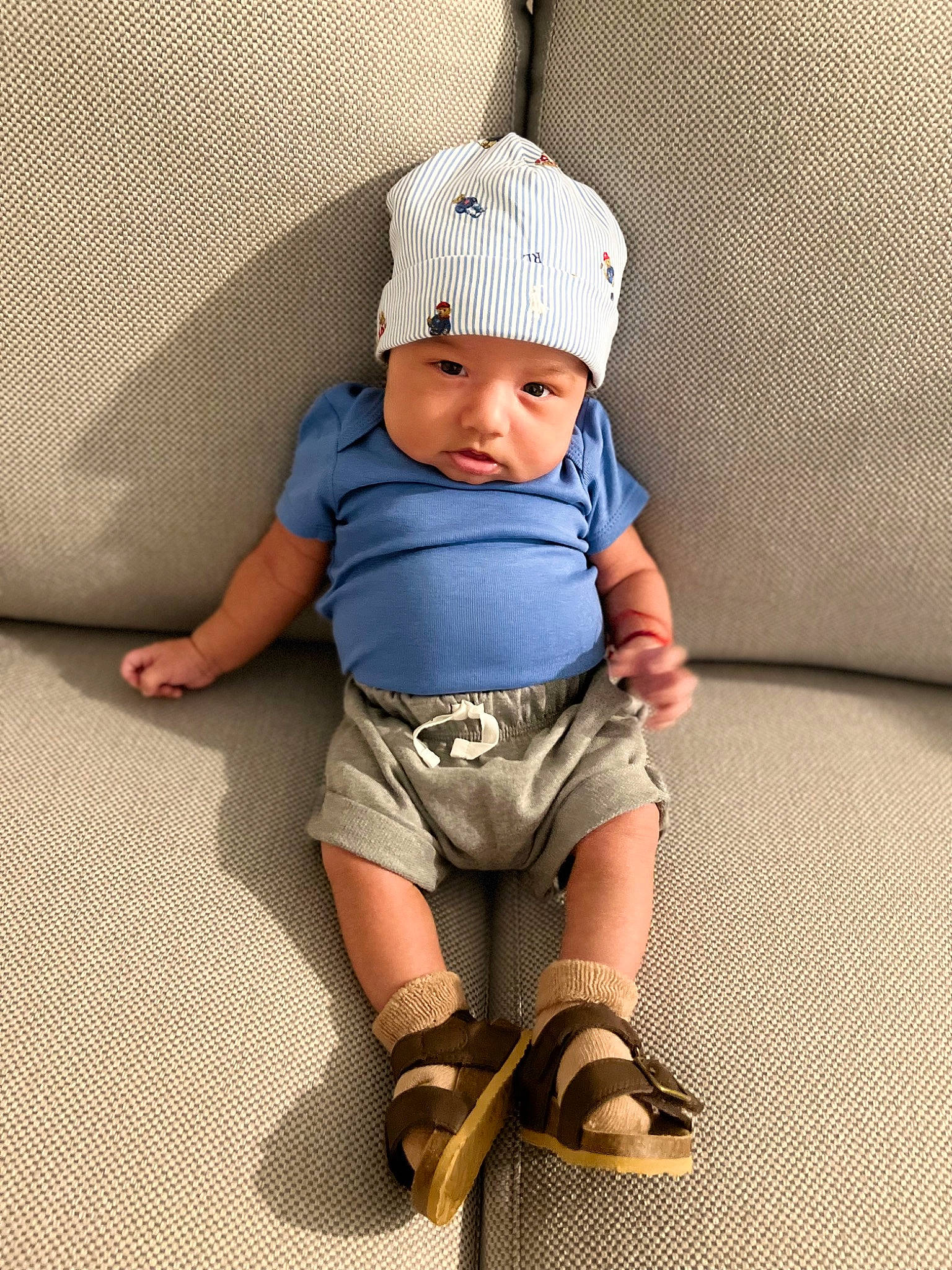 Allan joined the competition — help win amazing prizes! baby, baby_toddler_clothing, cap, child, comfort, costume_hat, electric_blue, fashion_accessory, foot, headwear, human_leg, knee, knit_cap, leg, pattern, person, sitting, sleeve, sock, t_shirt