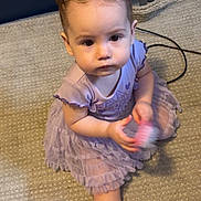 Brailee joined the competition — help win amazing prizes! toddler, child, baby, carpet, purple_dress, hair_buns, brush, indoor, floor, sitting, foot, sneakers, shelf, cute, curious, person, young_child, clothing, toy, home