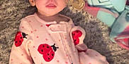 Aurora is registered to the contest to win money with this photo: baby, blanket, carpet, child, colorful, cozy, cute, face, home, indoor, infant, ladybug_pattern, lying_down, newborn, onesie, pacifier, person, resting, sleepwear, soft_texture
