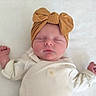 baby, sleeping, headband, bow, infant, cute, child, face, clothing, onesie, newborn, soft, fist, peaceful, portrait, closeup, skin, rest, lying_down, blanket