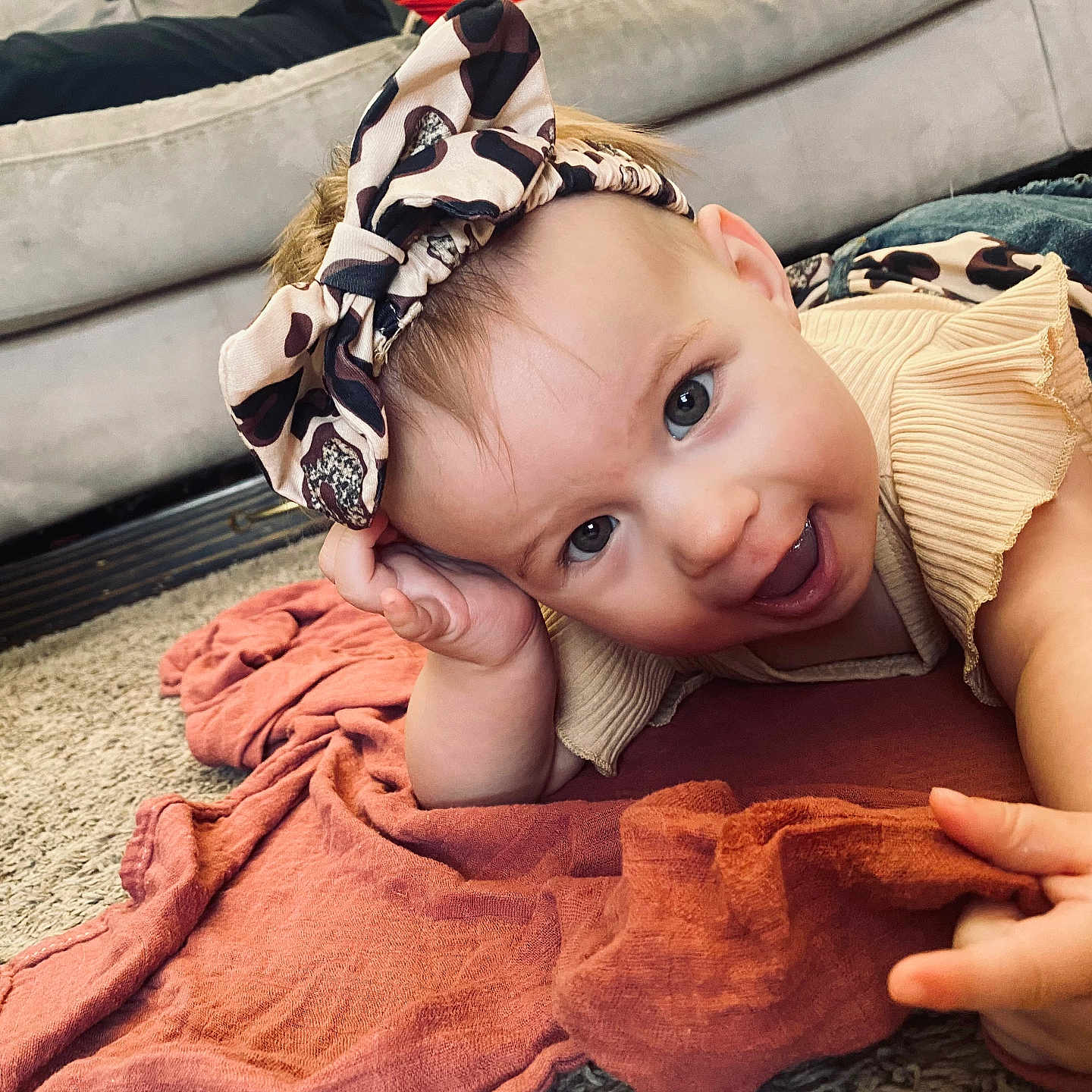 Payton is registered to the contest to win money with this photo: baby, blanket, bodypart, clothing, couch, cushion, face, finger, furniture, hand, happy, hat, head, homedecor, pants, person, photography, portrait, quilt, smile