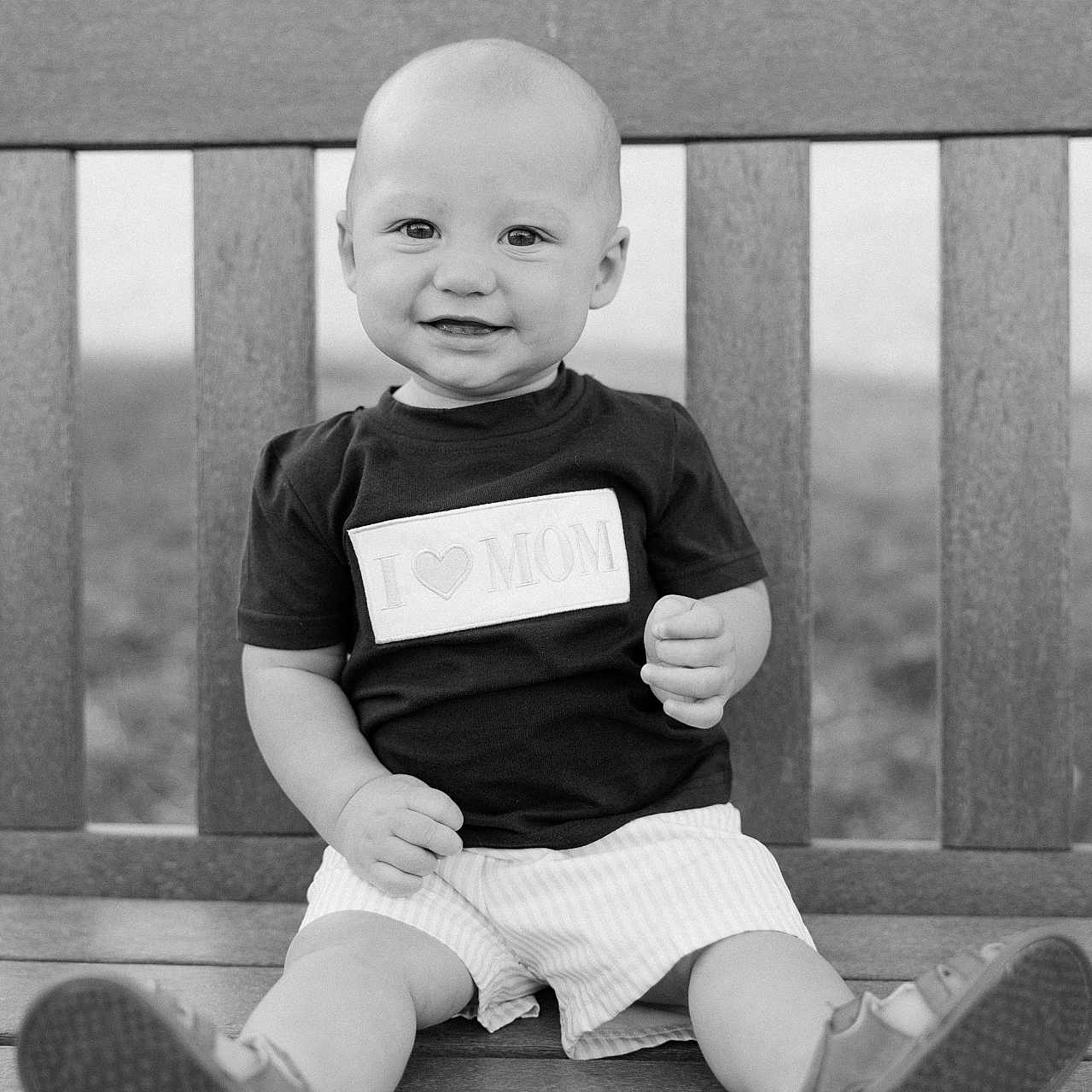Jalen is registered to the contest to win money with this photo: baby, bench, bodypart, clothing, face, finger, footwear, furniture, hand, happy, head, pants, person, photography, portrait, shoe, shorts, sitting, sneaker, t_shirt
