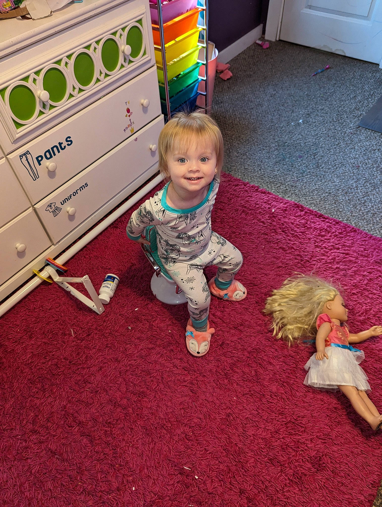 Mckenzie is registered to the contest to win money with this photo: carpet, child, clothes_dryer, companion_dog, floor, flooring, fun, grass, happy, hardwood, joy, person, play, room, sitting, smile, square, t_shirt, toddler, toy