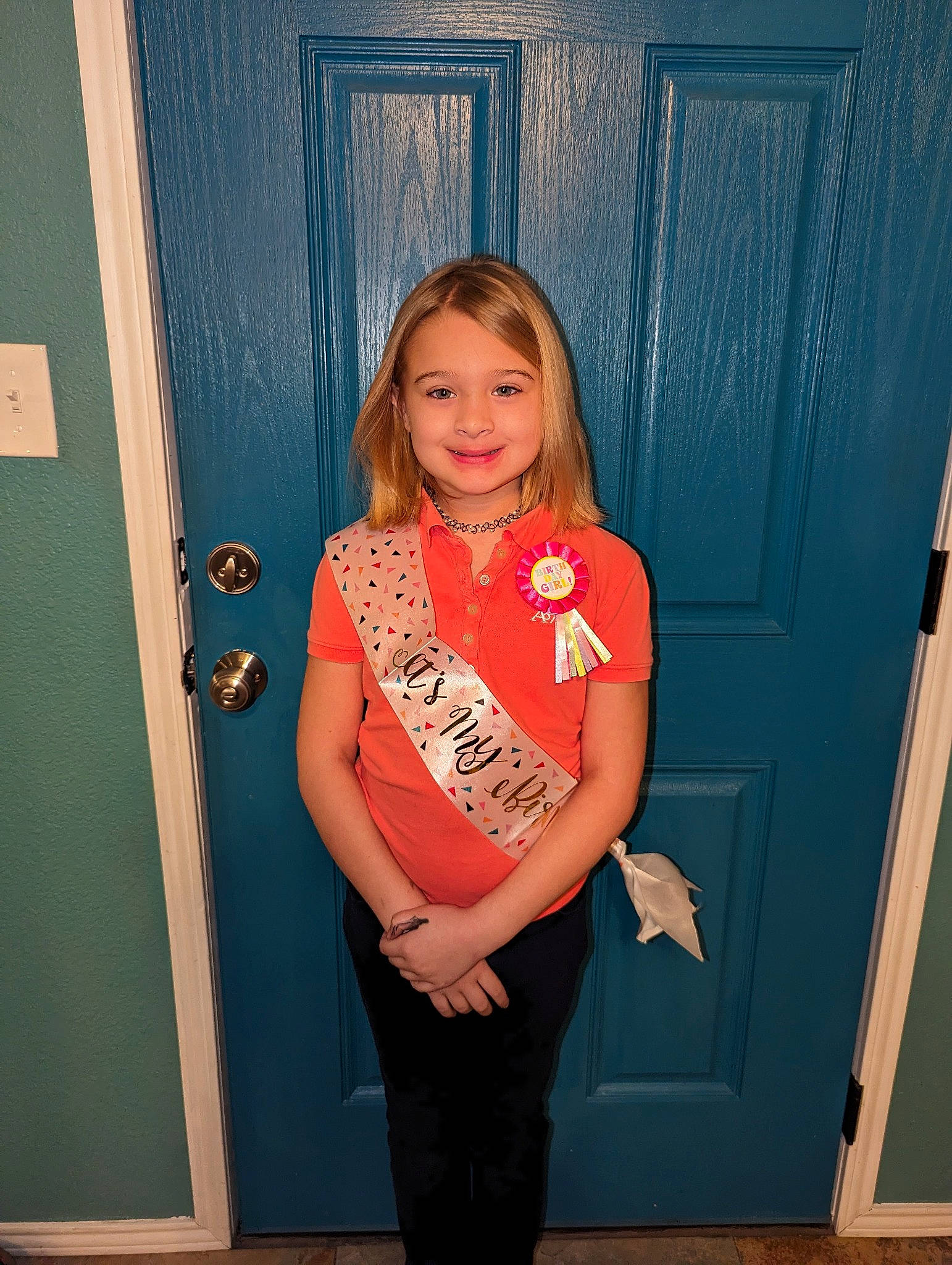 Lorelei is registered to the contest to win money with this photo: brown_hair, door, electric_blue, fun, happy, home_door, human_leg, joint, joy, knee, magenta, person, pink, room, sleeve, smile, standing, t_shirt, thigh, trunk