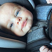 Nash is registered to the contest to win money with this photo: baby, infant, face, blue_eyes, car_seat, child, close_up, straps, comfort, soft_lighting, skin, expression, young_child, candid, portrait, seatbelt, clothing, hand, safety, infant_seat