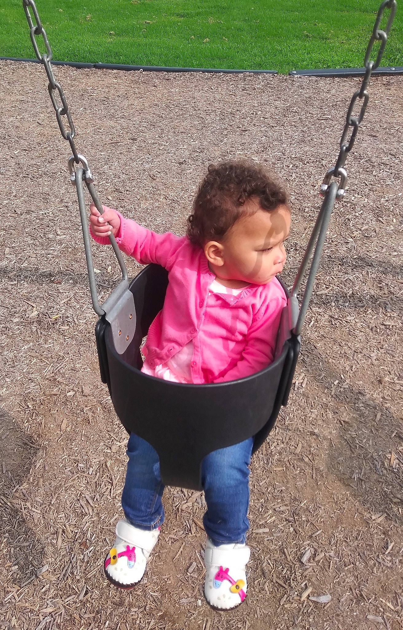 Katara is registered to the contest to win money with this photo: baby, baby_toddler_clothing, child, city, fun, grass, happy, leisure, outdoor_play_equipment, people_in_nature, person, plant, play, playground, recreation, sitting, spring, swing, toddler, tree