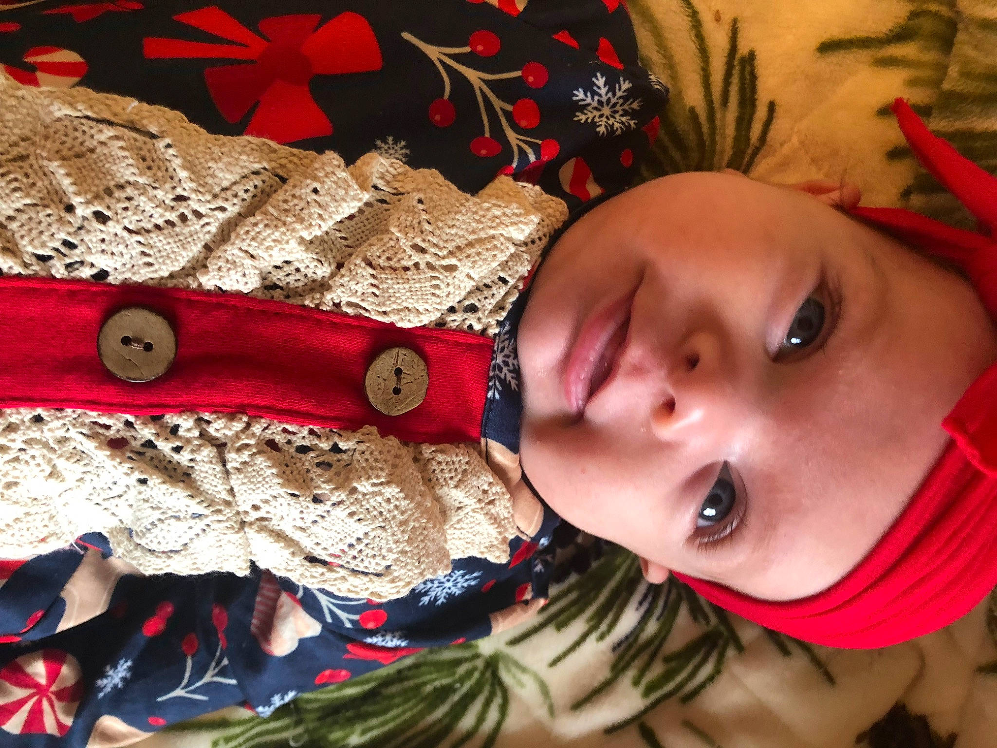 Bethany is registered to the contest to win money with this photo: baby, close_up, eyelash, happy, headgear, headwear, jewellery, leaf, linens, neck, orange, pattern, person, plant, red, skin, sleeve, smile, textile, toddler