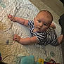 Rhyker is registered to the contest to win money with this photo: baby, blanket, carpet, child, crawling, cute, exploring, face, floor, hand, head, indoor, infant, pacifier, plush_toy, quilt, striped_clothing, toy, tummy_time, young_child