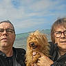Elsa participe au concours pour gagner de l'argent avec cette photo : dog, people, man, woman, selfie, portrait, beach, seaside, ocean, water, sky, clouds, outdoor, vacation, family, glasses, windy, pet, leash, jacket