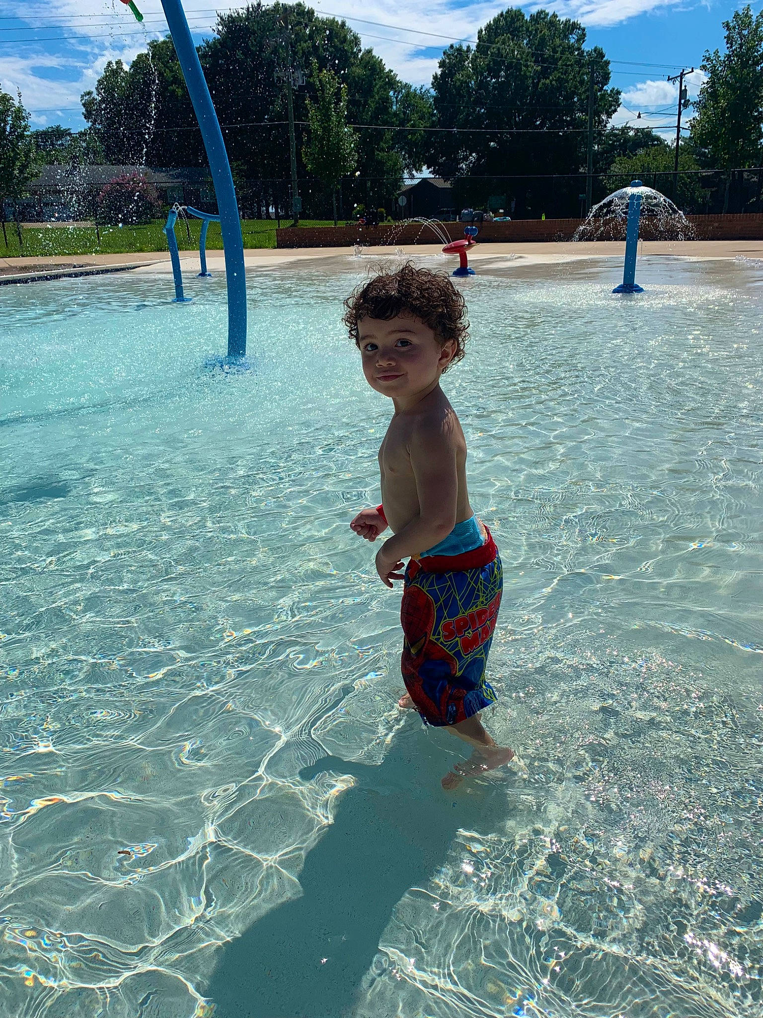 Omari joined the competition — help win amazing prizes! aqua, azure, barefoot, bathing, blue, cloud, fun, human_settlement, leisure, mammal, morning, person, recreation, sky, swimming_pool, swimwear, toddler, tree, vertebrate, water