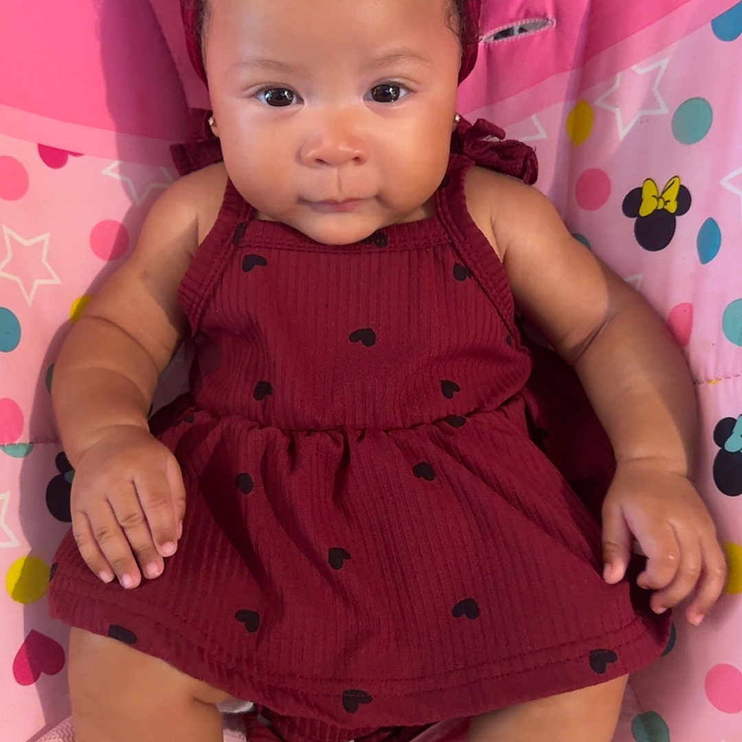 Zailey Dior is registered to the contest to win money with this photo: baby, bow, child, colorful, cushion, dots, dress, face, footwear, hands, headband, indoor, legs, maroon, minnie_mouse, pattern, polka_dots, sitting, skin, stars