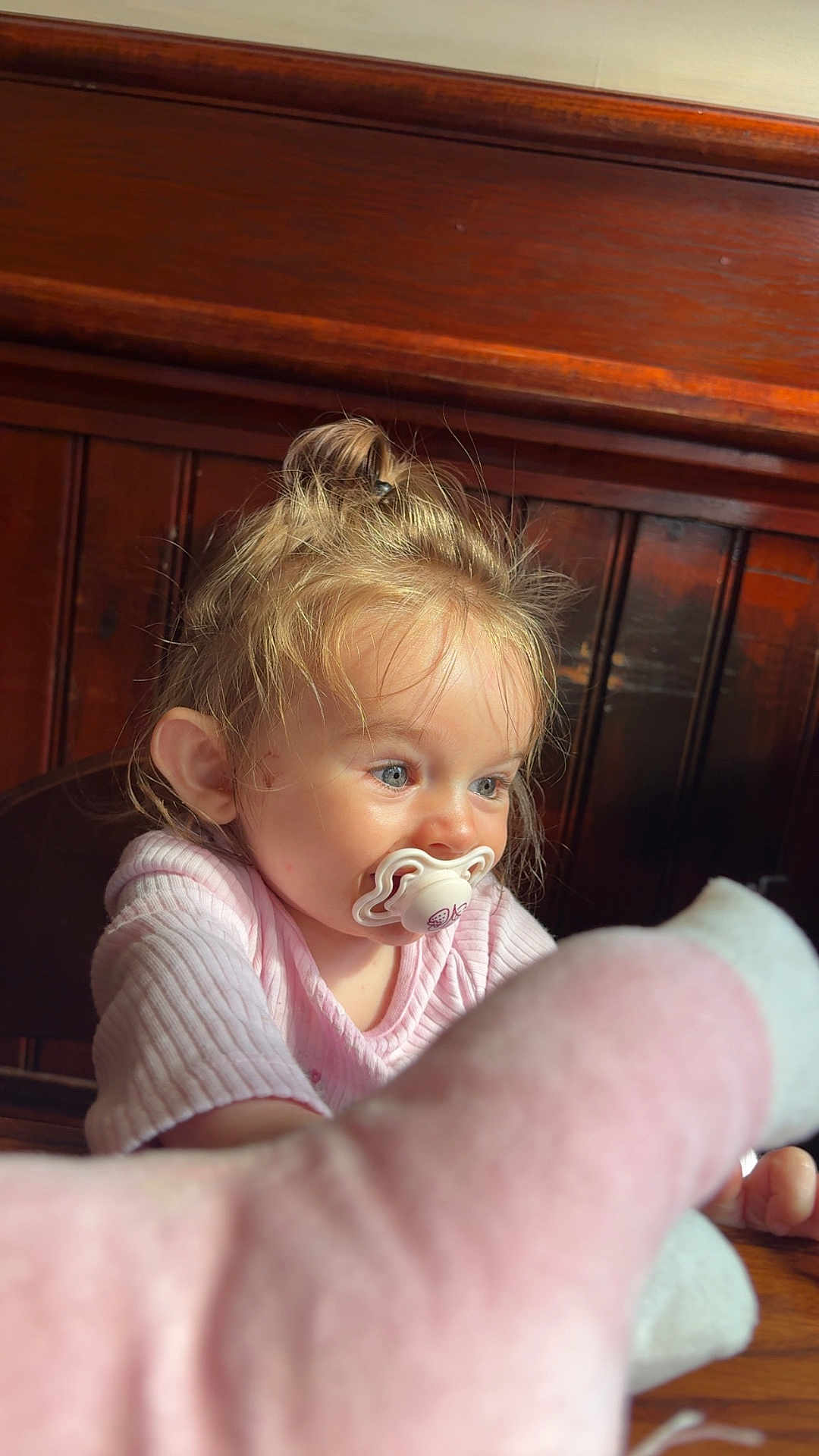 Isla-Robyn is registered to the contest to win money with this photo: child, toddler, pacifier, pink_clothing, blond_hair, blue_eyes, toy, fuzzy_toy, wooden_background, indoor, curious, cute, portrait, person, sitting, baby, young_child, long_sleeve, light, natural_light