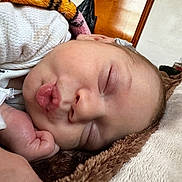 Onyx joined the competition — help win amazing prizes! baby, sleeping, face, blanket, cozy, closeup, puckered_lips, infant, resting, soft_texture, hand, peaceful, indoors, cute, child, skin, eyelids, nose, mouth, warm