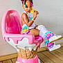 Stori Isabella joined the competition — help win amazing prizes! toddler, child, girl, ice_cream_chair, colorful_clothing, ruffled_leg_warmers, white_shoes, toy_ice_cream, hair_clips, braided_hair, wooden_floor, indoor, playful, cute, fashion, seated, bright_colors, smiling, studio, fun