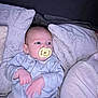 Theo is registered to the contest to win money with this photo: baby, pacifier, onesie, pillow, blanket, infant, sleepwear, bed, resting, child, cute, indoor, soft, comfort, portrait, small_hands, looking, cozy, newborn, face