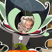 Theo joined the competition — help win amazing prizes! baby, child, costume, halloween, vampire, cartoon, cutout, pumpkin, outdoor, green, orange, face, fur, cute, person, wood, board, holiday, seasonal, fun