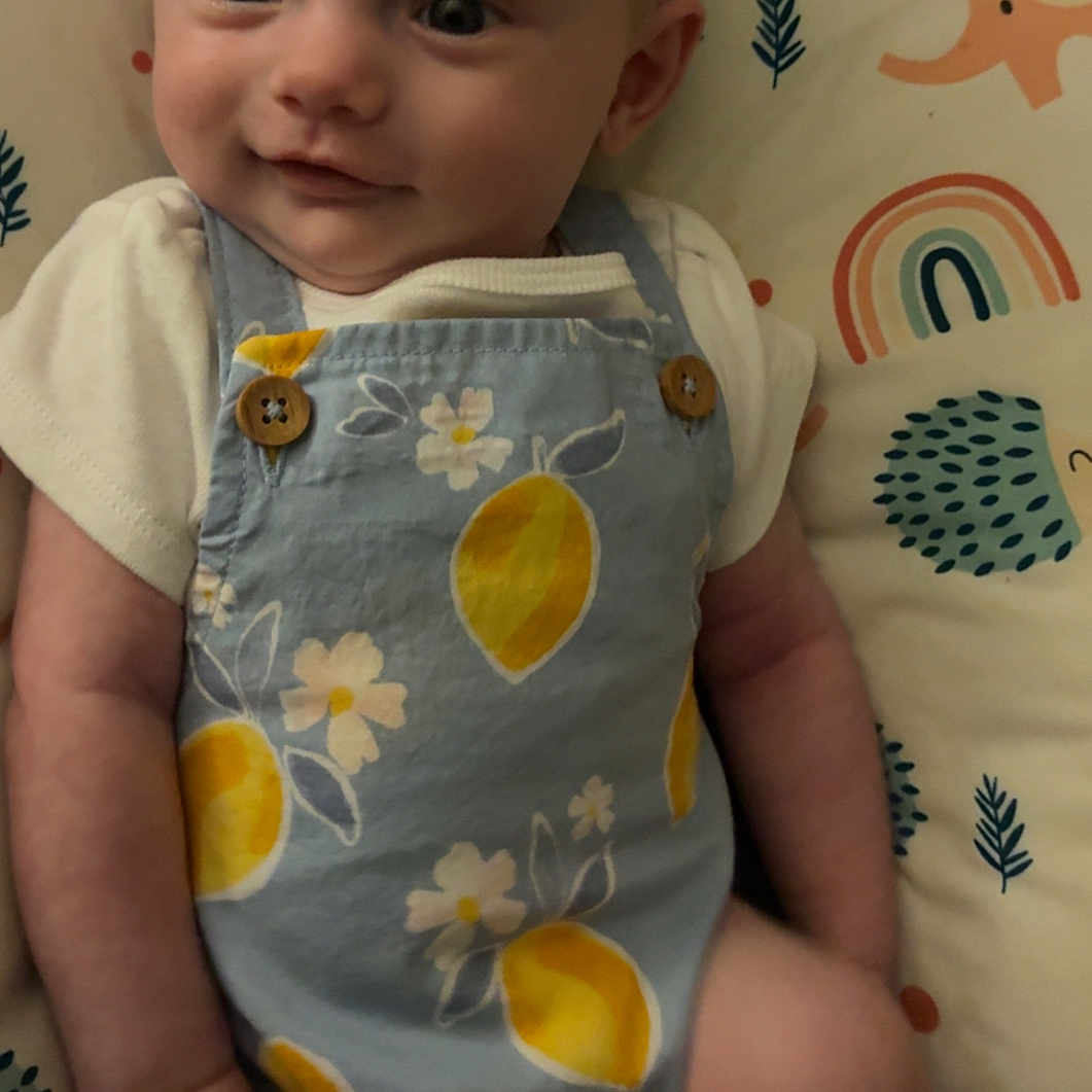 Brinley joined the competition — help win amazing prizes! baby, child, clothing, cushion, cute, elephant, face, flower, happy, headband, hedgehog, indoor, infant, lemons, lying, pattern, person, portrait, rainbow, smile