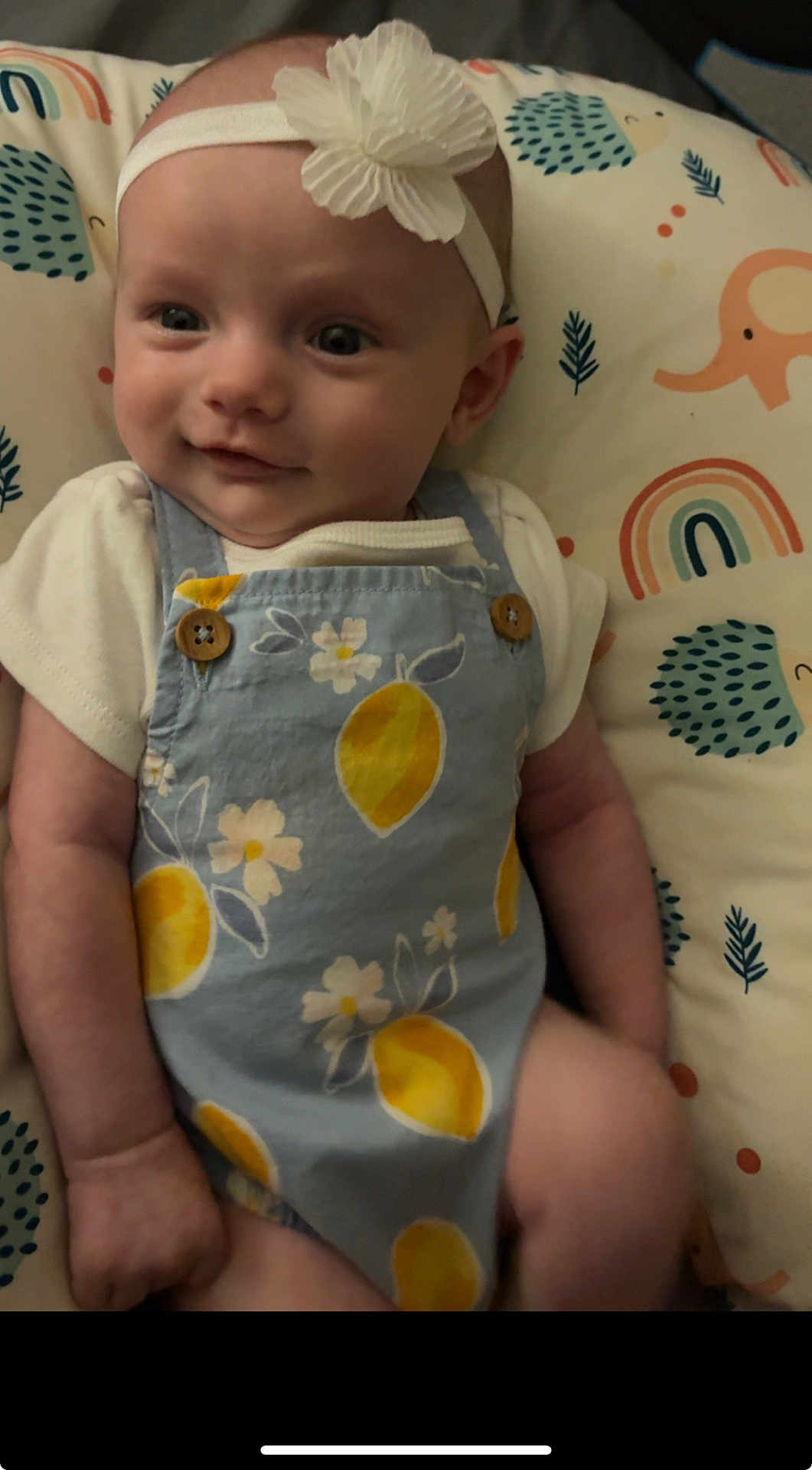 Brinley joined the competition — help win amazing prizes! baby, infant, headband, flower, clothing, pattern, lemons, cushion, rainbow, elephant, hedgehog, smile, face, person, child, cute, indoor, portrait, happy, lying