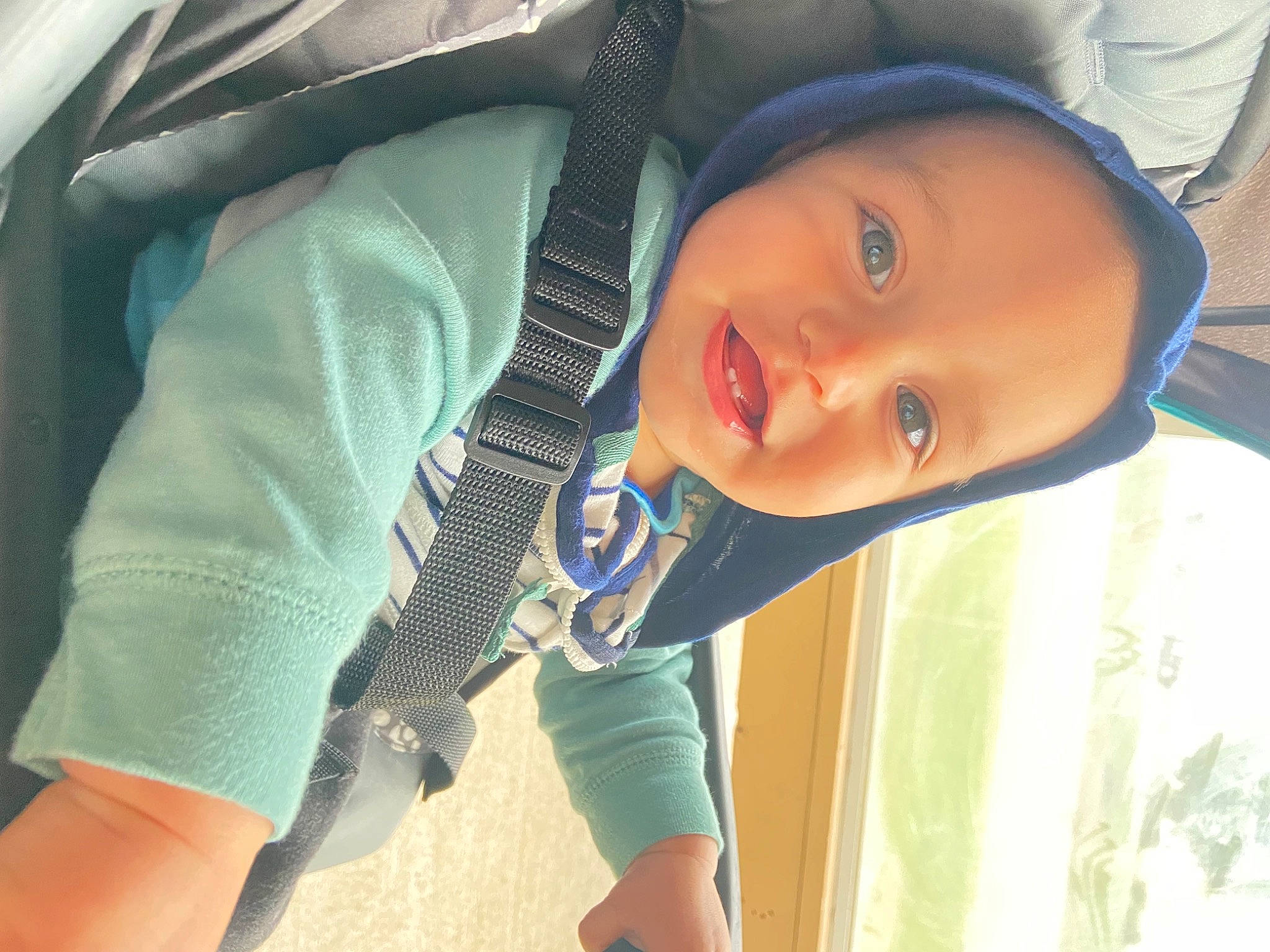 Emanuel is registered to the contest to win money with this photo: baby, baby_toddler_clothing, cheek, comfort, cool, electric_blue, eyebrow, happy, hat, iris, lip, mouth, nose, person, skin, sleeve, smile, thigh, toddler, tree