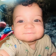 Kvontae joined the competition — help win amazing prizes! toddler, child, curly_hair, face, eyes, smile, indoor, toy, playful, cute, person, baby, clothing, short_sleeve, expression, skin, chubby_cheeks, closeup, infant, young_child