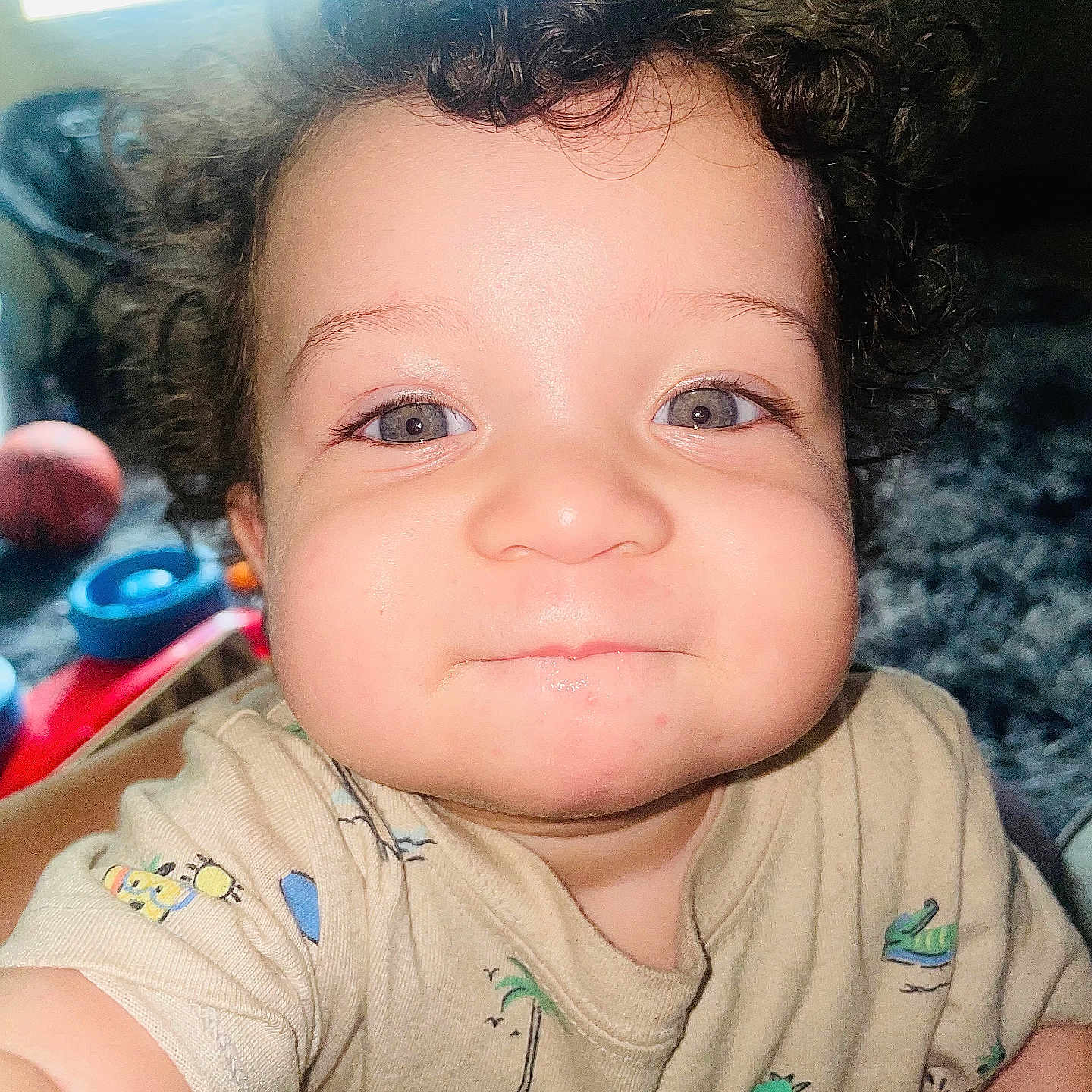 Kvontae joined the competition — help win amazing prizes! baby, child, chubby_cheeks, closeup, clothing, curly_hair, cute, expression, eyes, face, indoor, infant, person, playful, short_sleeve, skin, smile, toddler, toy, young_child