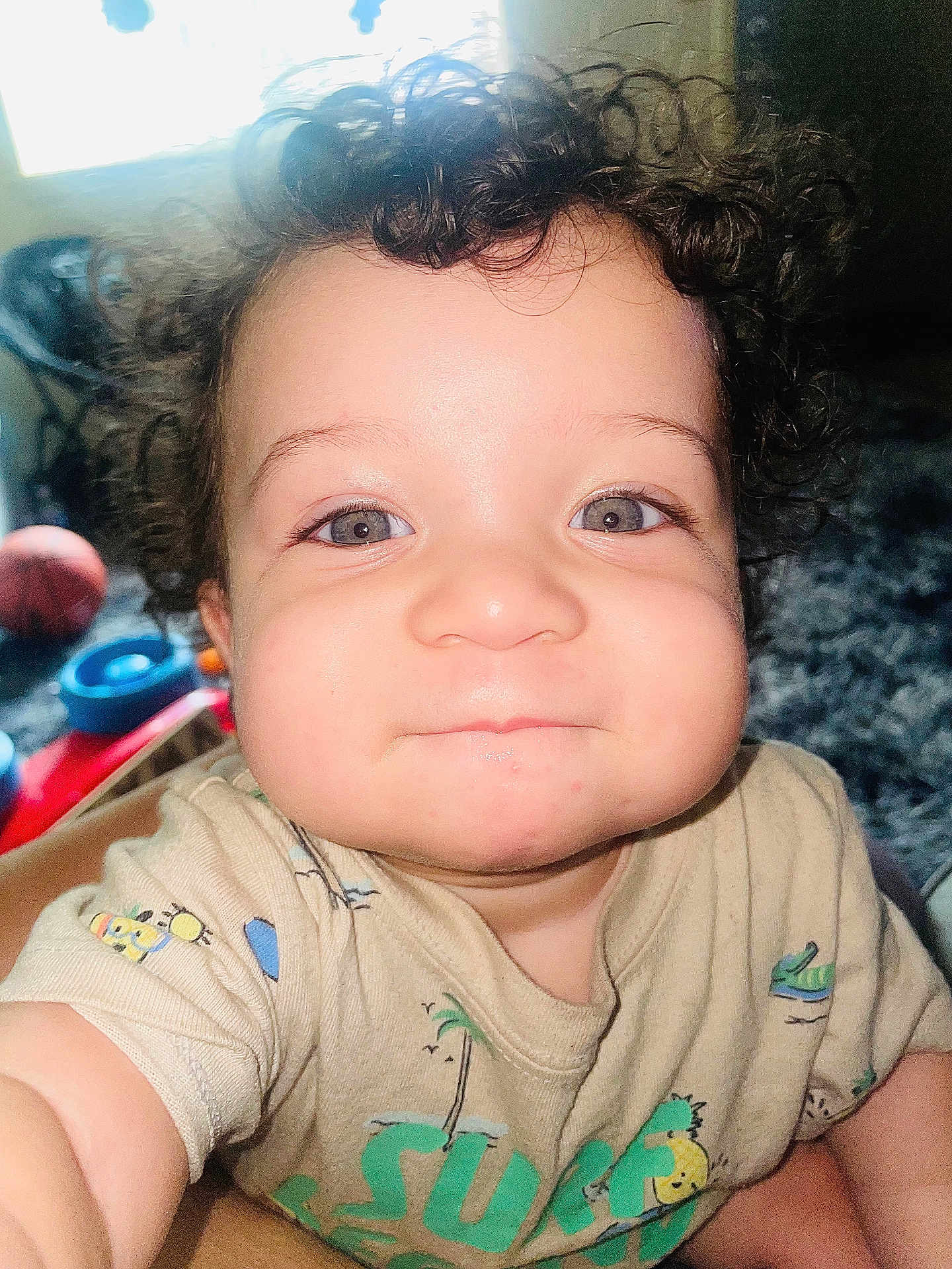 Kvontae joined the competition — help win amazing prizes! toddler, child, curly_hair, face, eyes, smile, indoor, toy, playful, cute, person, baby, clothing, short_sleeve, expression, skin, chubby_cheeks, closeup, infant, young_child