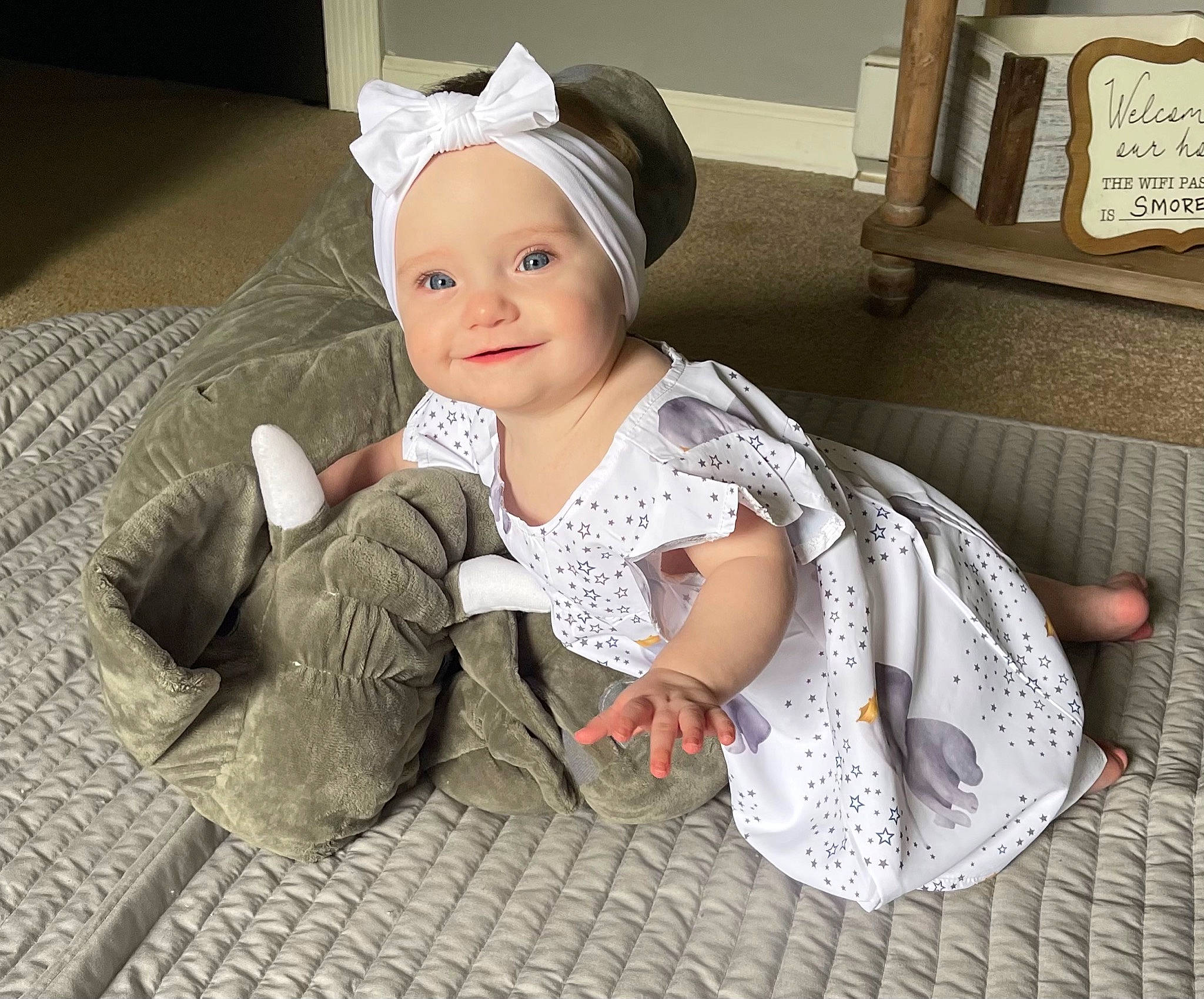 Aurora is registered to the contest to win money with this photo: baby, baby_toddler_clothing, cap, child, comfort, fashion_accessory, finger, floor, flooring, foot, happy, headgear, headwear, joy, outerwear, pattern, person, room, sitting, skin
