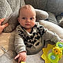 Jenson is registered to the contest to win money with this photo: baby, infant, child, sitting, couch, pillow, sweatshirt, bats, toy, star_toy, rattle, yellow_toy, hand, face, drool, eyes, cozy, indoor, soft_toys, person