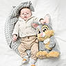 Kenzo participe au concours pour gagner de l'argent avec cette photo : baby, infant, plush_toy, stuffed_animal, bunny, white_background, knit_sweater, beige_pants, socks, soft_pillow, lying_down, child, cute, indoors, portrait, cozy, toy, smiling, childhood, warm_clothing